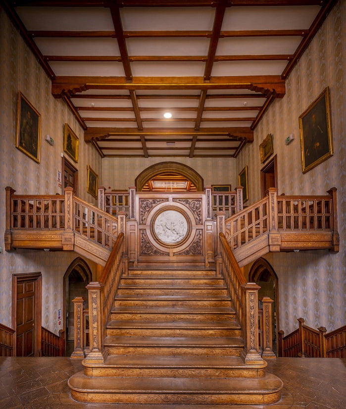 Beautiful bride posing on detailed wooden stairway