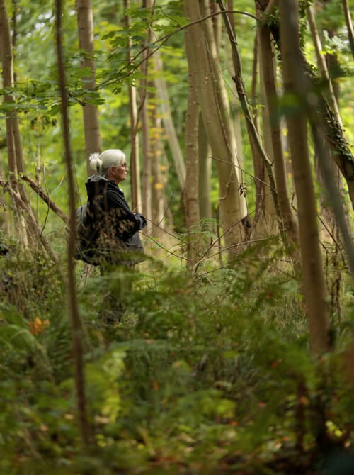 Woman in forest taking part in team building activities Scotland